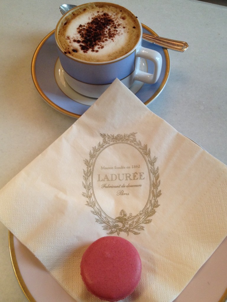 Enjoying a fresh macaroon and hot cappuccino from Laduree.